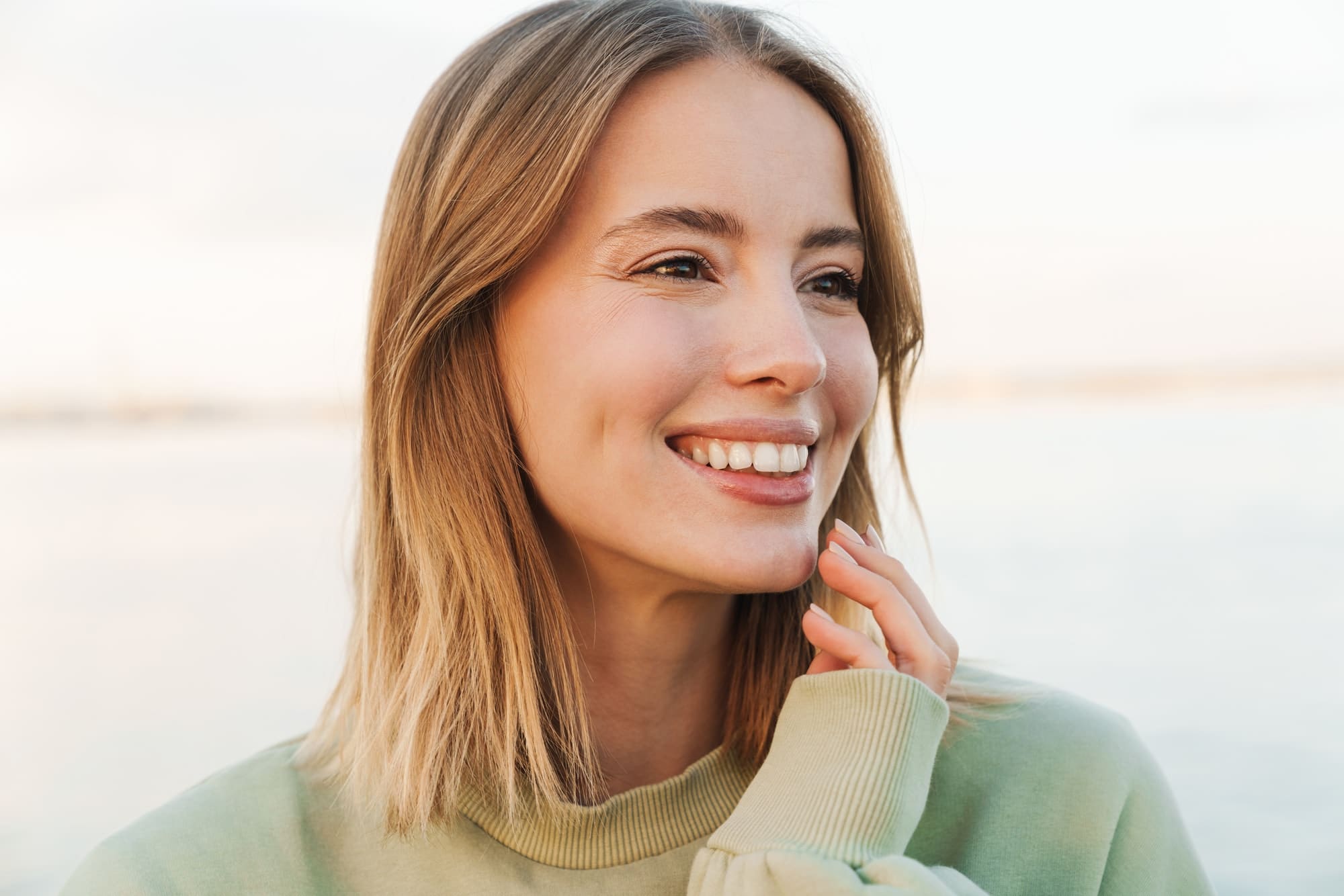 Portrait of happy woman smiling and looking aside